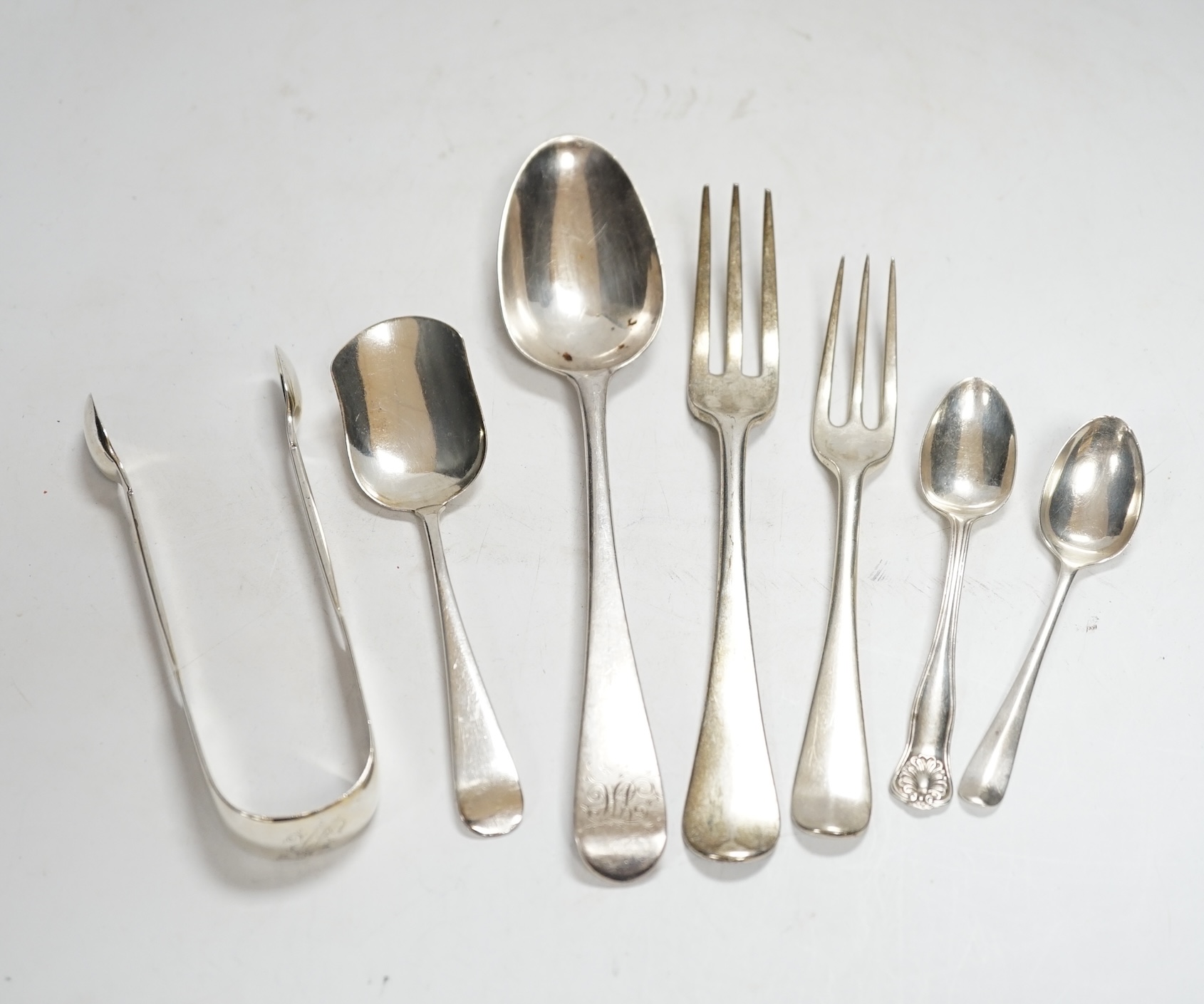 A small quantity of 19th century and later silver flatware, including three pairs of Georgian sugar tongs and nine 19th century and later three pronged forks